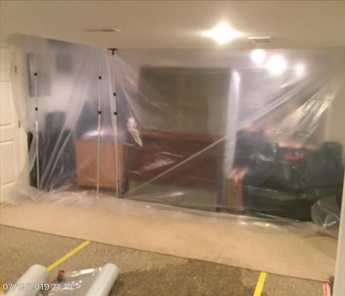 Plastic containment separating room in Solon home