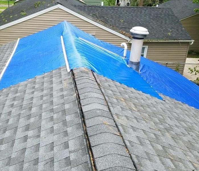 Blue tarp on roof covering damage