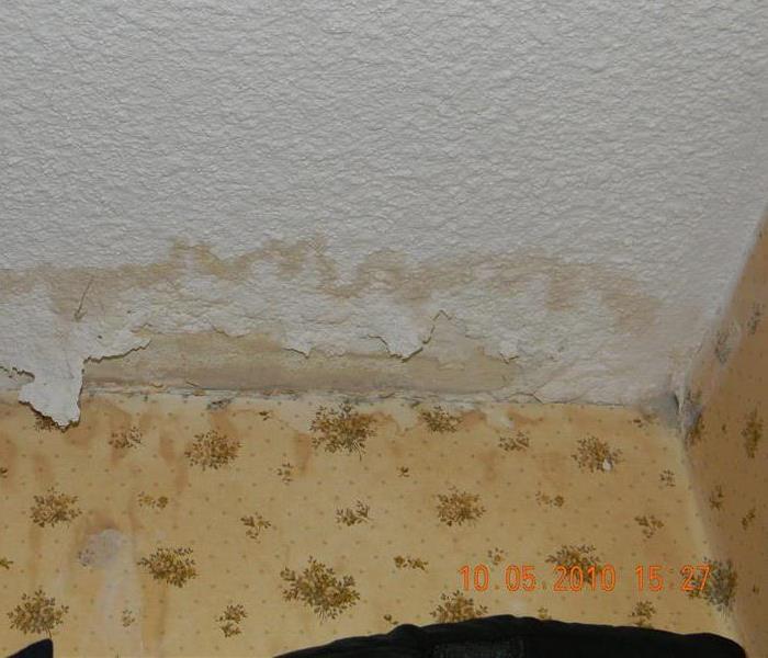 Part of the ceiling peeling away due to water damage
