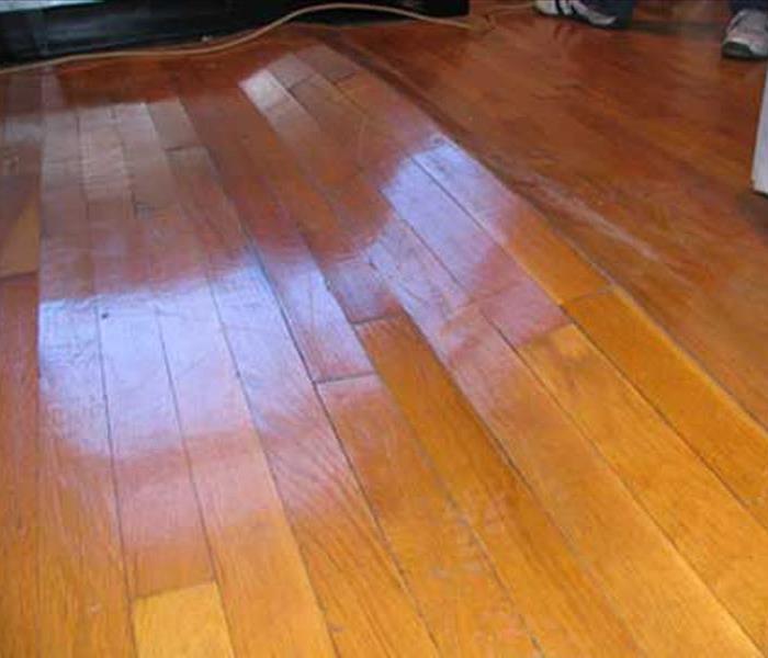 a wooden floor damaged by water